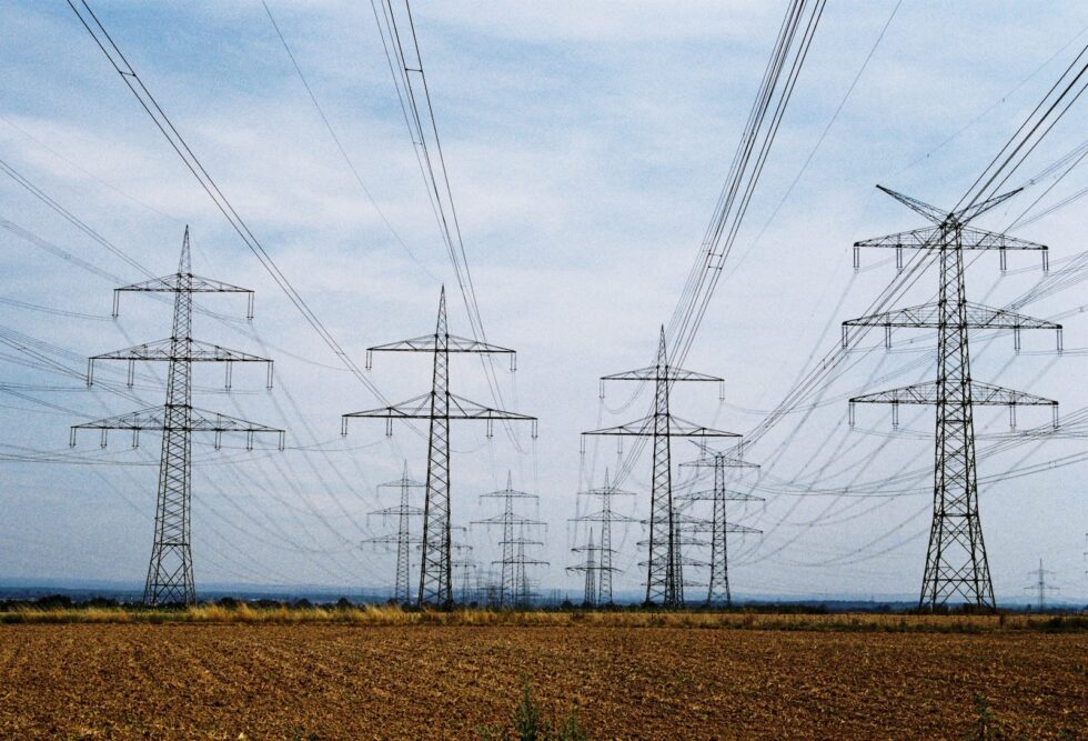 a row of power lines in the middle of a field