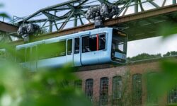 white and green train on rail tracks